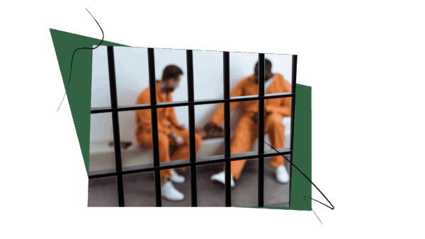 two men dressed in orange prison jumpsuits, behind bars