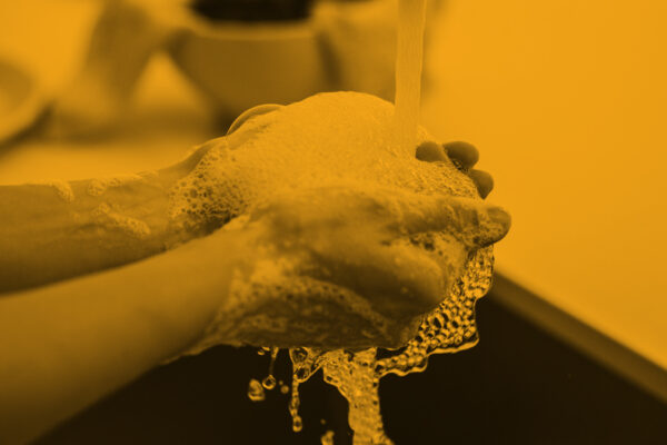 Generic_PersonWashingHands-BlackOrange_1200-675.jpg
