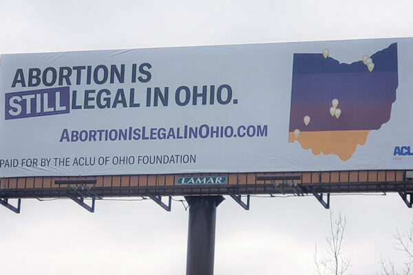 Billboard that says Abortion is still legal in Ohio with a multicolored map of Ohio