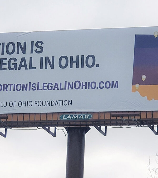 Billboard that says Abortion is still legal in Ohio with a multicolored map of Ohio