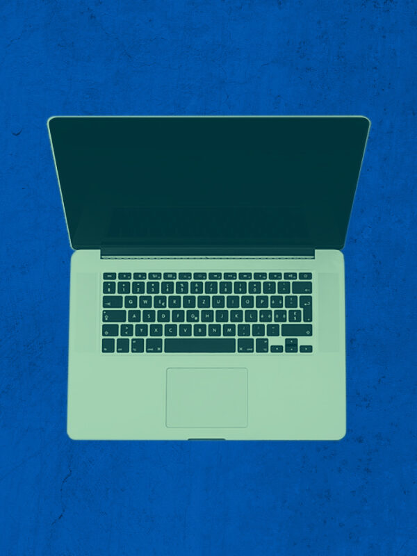 Laptop with a green color overlay on a textured blue background