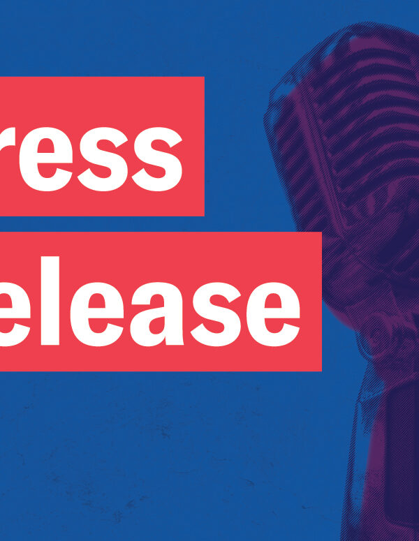 Press Release in white font in red rectangles, a retro microphone with navy and purple color overlay on a textured blue background