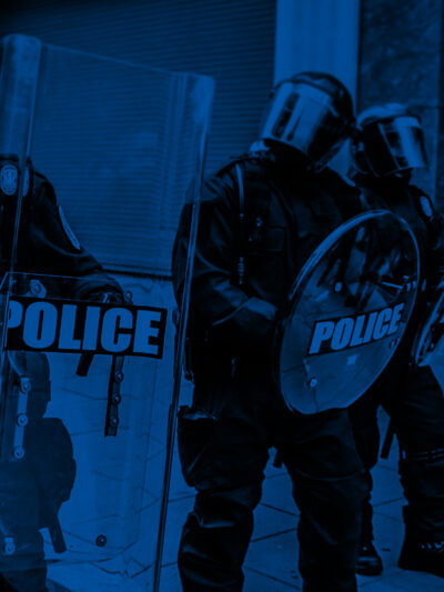 Militarized police in riot gear with a black and blue color overlay