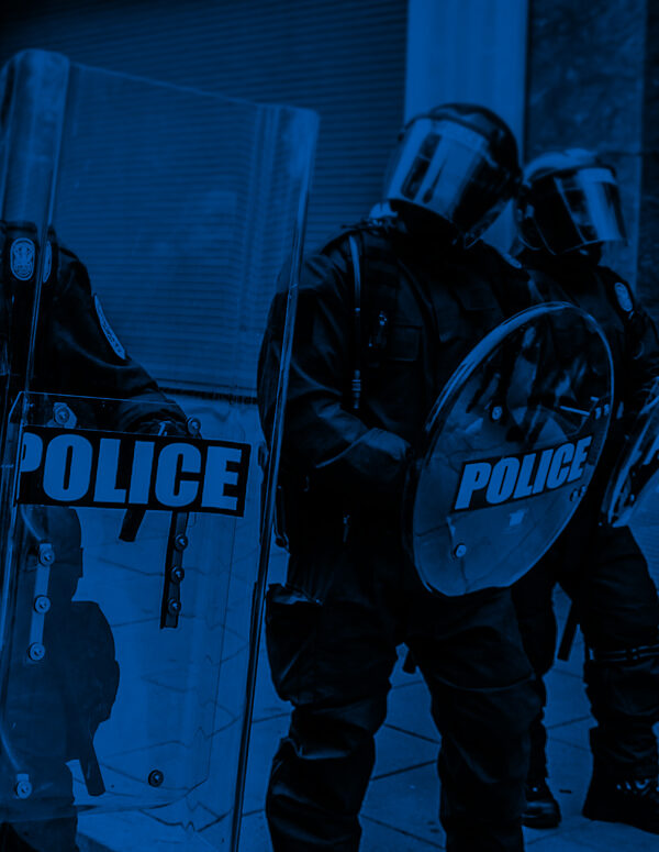 Militarized police in riot gear with a black and blue color overlay