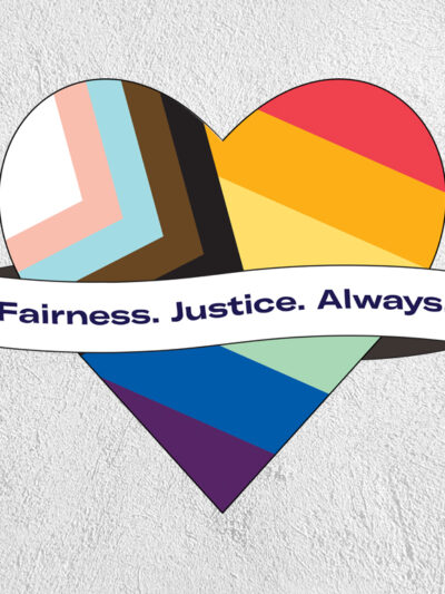 Pride flag in the shape of a heart with a ribbon across the front that says 'Fairness. Justice. Always.' on a greay textured background