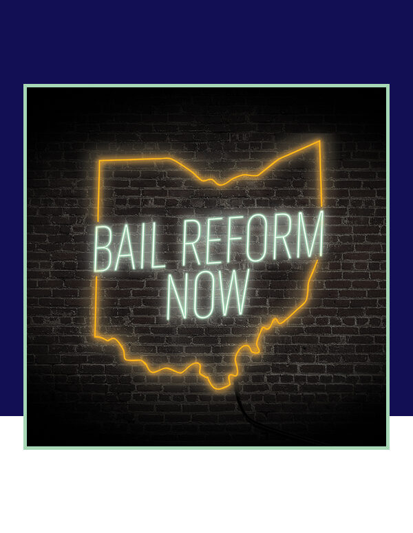 'Bail Reform Now' neon sign on a black brick background