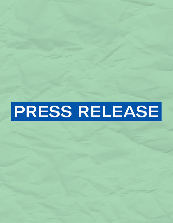 The words 'Press Release' in white font on a blurerectangle on a mint green color paper texture background