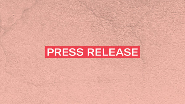 The words 'Press Release' in white font on a red rectangle on an pink concrete texture background