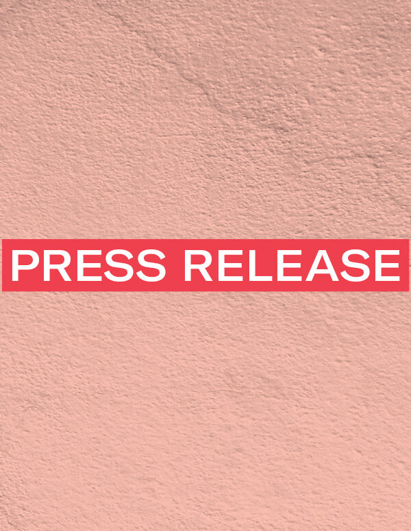 The words 'Press Release' in white font on a red rectangle on an pink concrete texture background