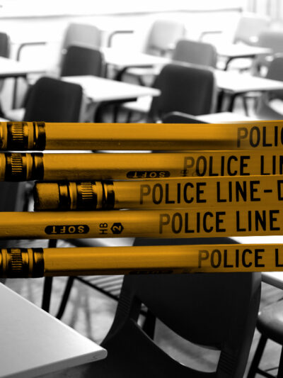 Graphic of yellow pencils combined with police tape stating "Police Line Do Not Cross." Pencils are in front of a black and white photo of a classroom with empty desks.