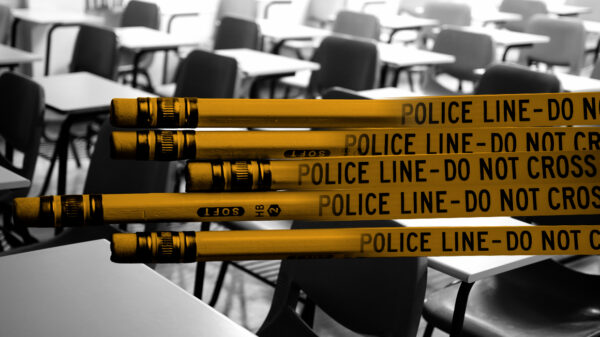 Graphic of yellow pencils combined with police tape stating "Police Line Do Not Cross." Pencils are in front of a black and white photo of a classroom with empty desks.