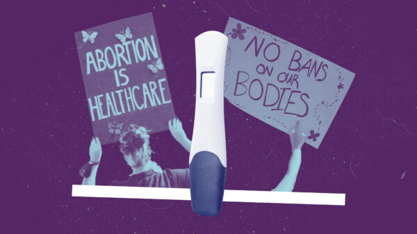 Two pro-abortion protest signs and a pregnancy test