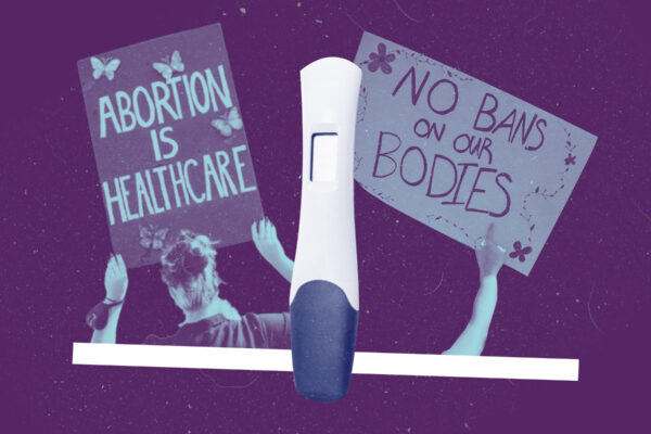 Two pro-abortion protest signs and a pregnancy test