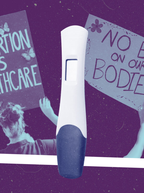 Two pro-abortion protest signs and a pregnancy test