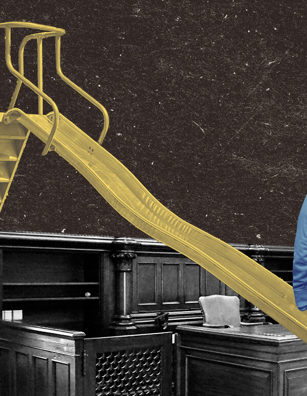 Kid facing the interior of a courtroom with a yellow slide placed over the table