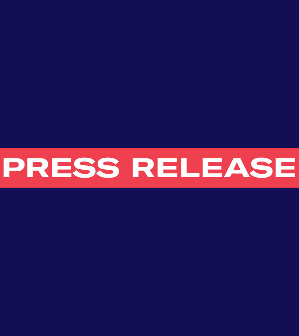 The words 'Press Release' in white font in a red rectangle on a navy background