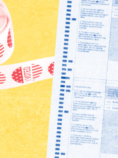 blurred ballot with roll of red I voted stickers