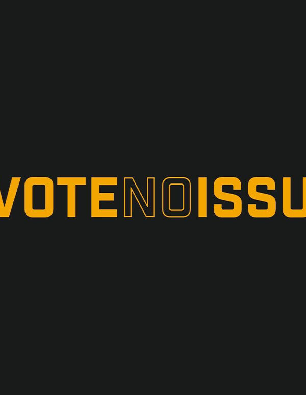 The words 'Vote No Issue 1' in yellow font on a black background