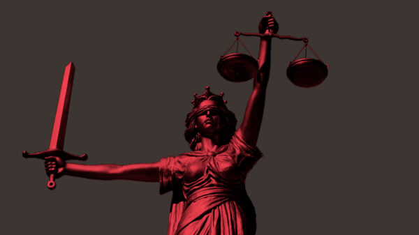 Lady Justice with a red color overlay on a grey background