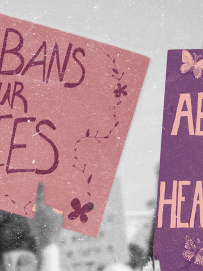 Protest signs reading "No Bans on our Bodies" and "Abortion is Healthcare"