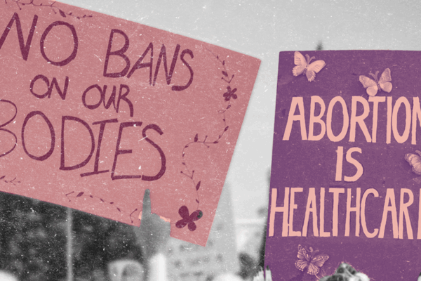 Protest signs reading "No Bans on our Bodies" and "Abortion is Healthcare"
