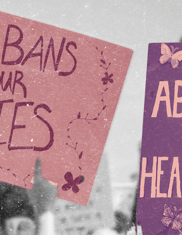 Protest signs reading "No Bans on our Bodies" and "Abortion is Healthcare"
