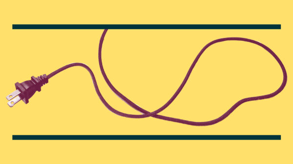 Maroon electrical plug and cord on a yellow backgound