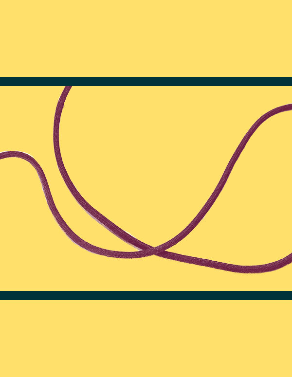 Maroon electrical plug and cord on a yellow backgound