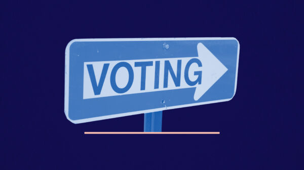 Blue and white 'voting' sign on a navy background