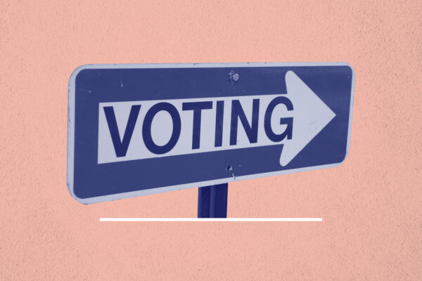 Blue and white 'voting' sign on a navy background