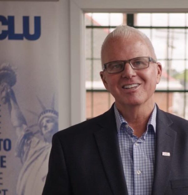 White man with glasses smiling