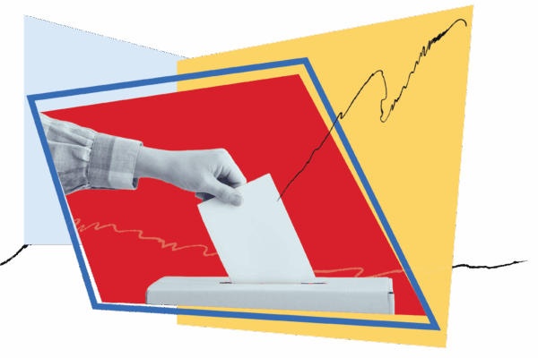hand placing a ballot into a ballot box with asymetrical red yellow and blue shapes