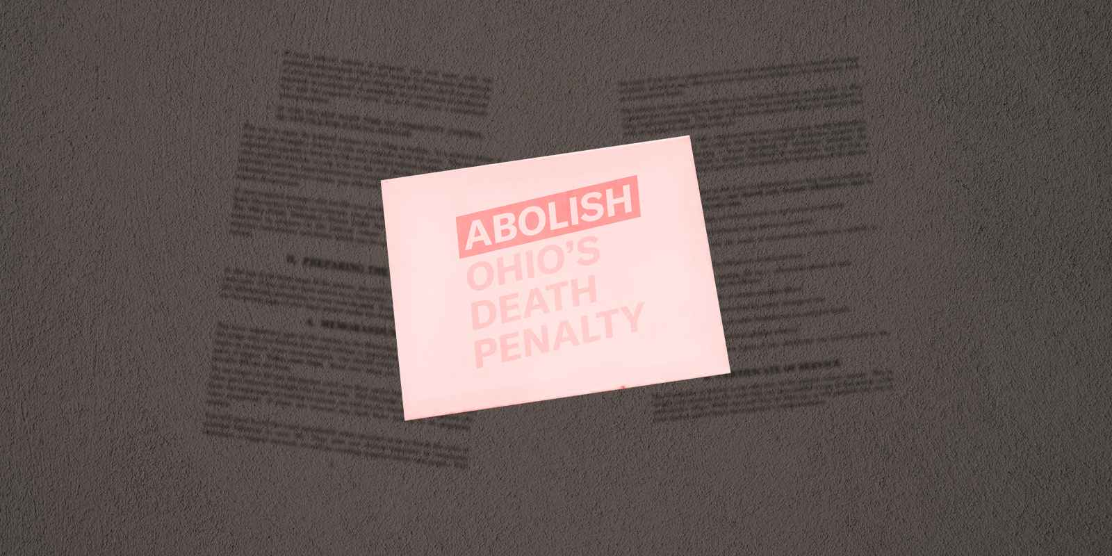A sign that reads 'Abolish Ohio's Death Penalty' on a textured grey background