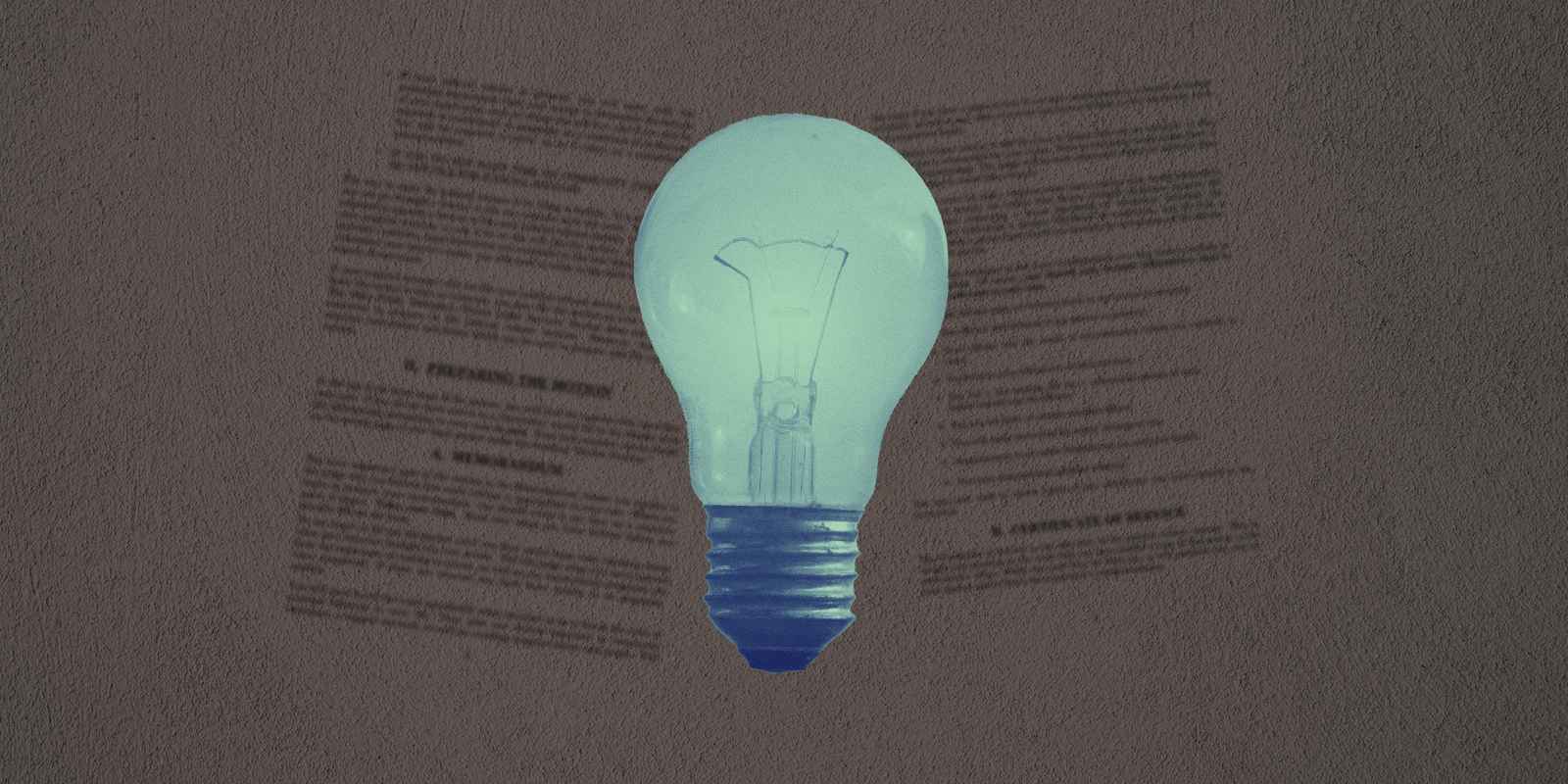 A lightbulb on a textured grey background