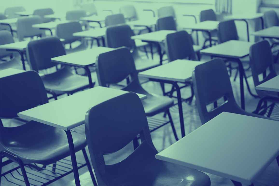 A classroom with empty chairs and desks with a navy and mint color overlay