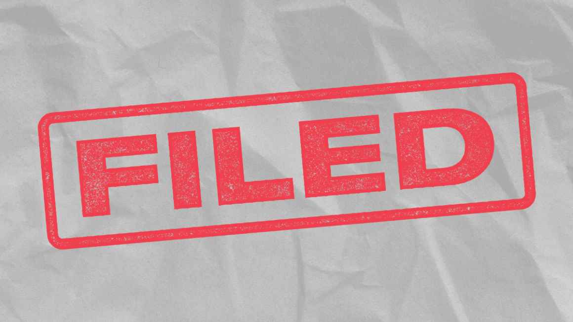 The word 'Filed' in red font, mimicking a rubber stanmp on a light grey textured background