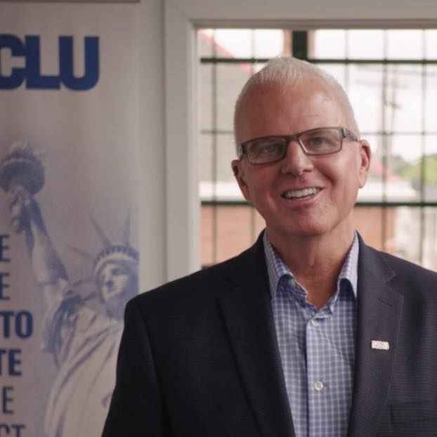 White man with glasses smiling