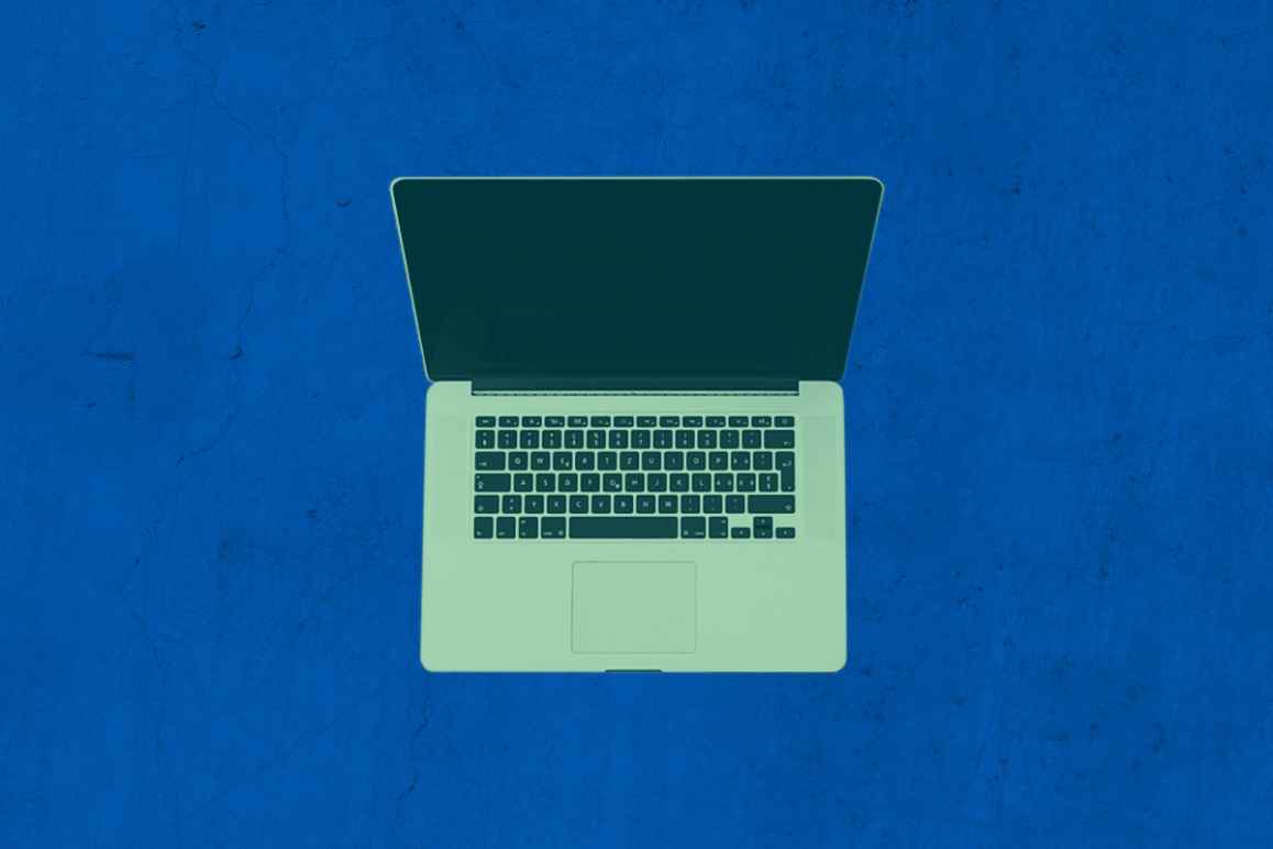 Laptop with a green color overlay on a textured blue background