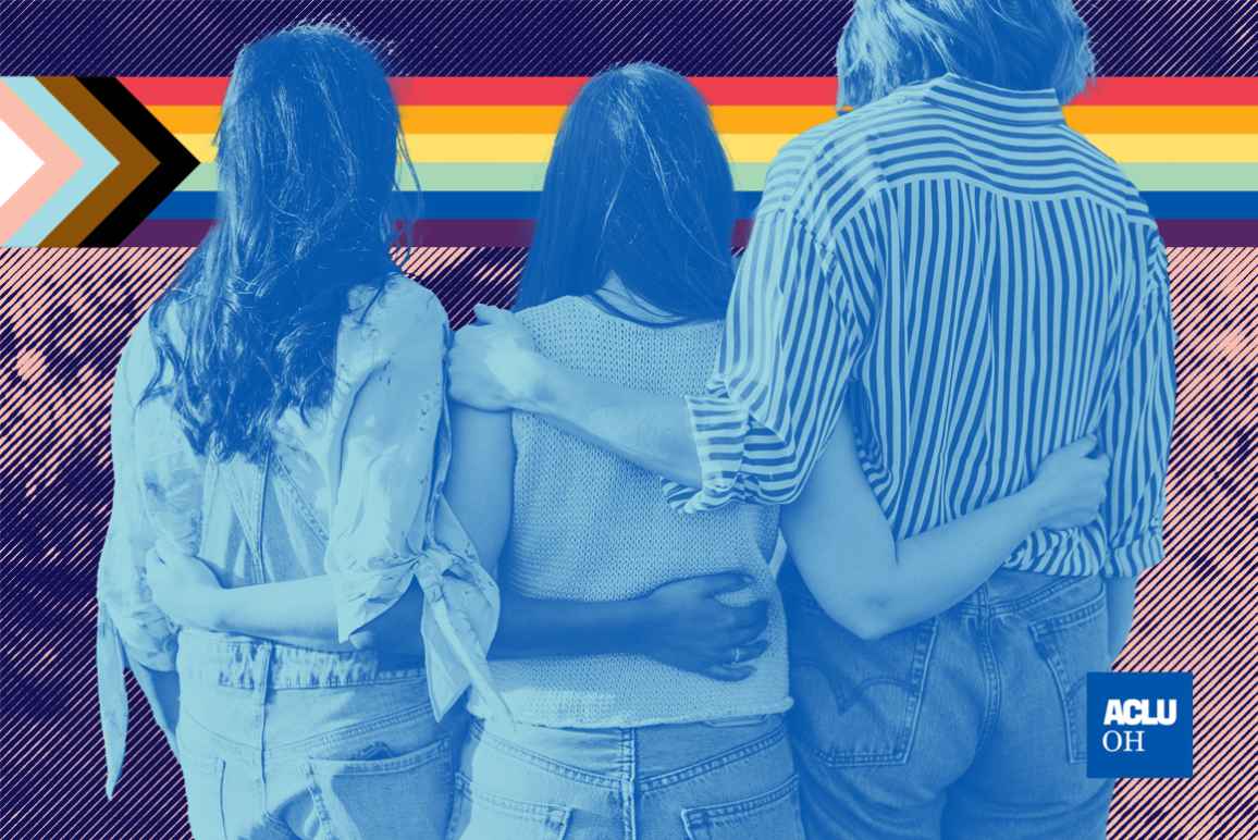 Image of three young people with their arms around each other and an LGBTQ+ pride flag in the background