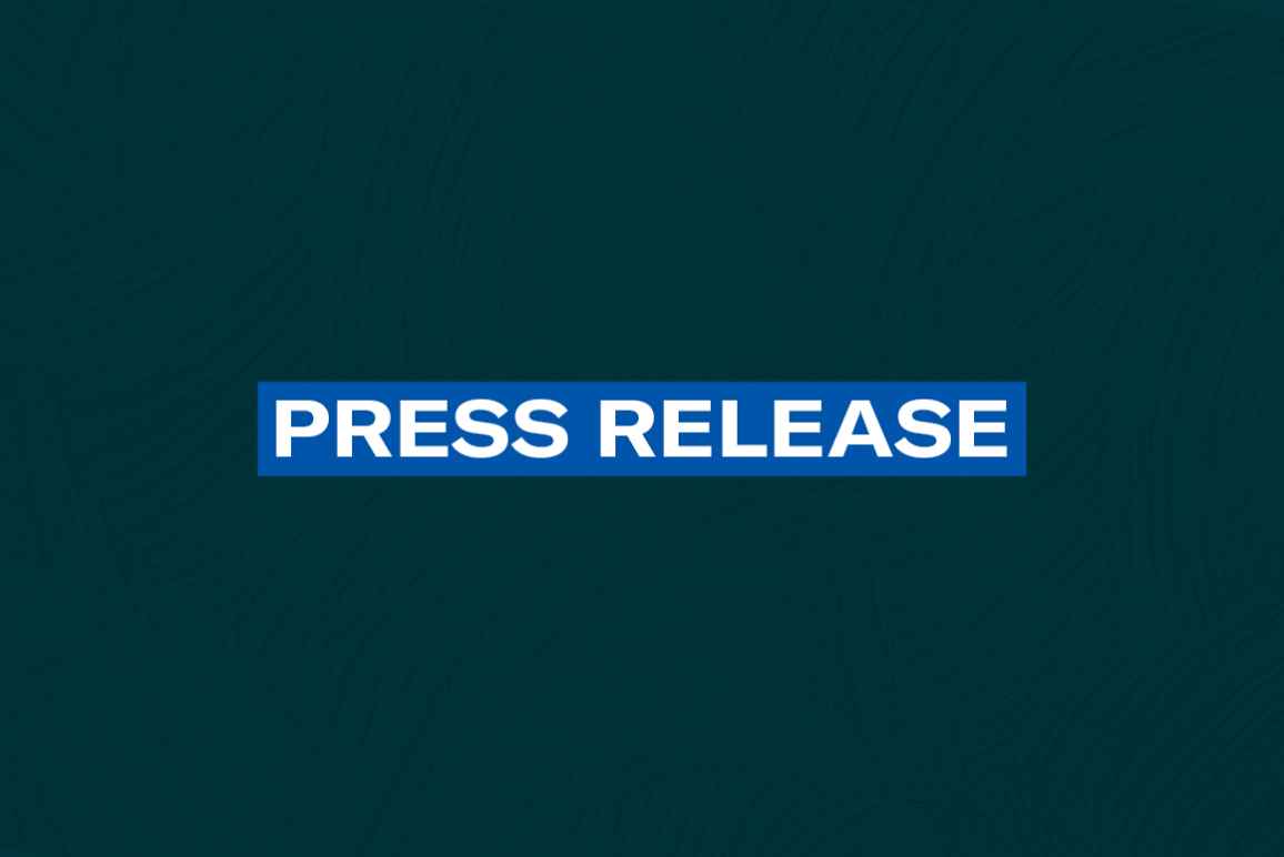 The words 'Press Release' in white font on a blue rectangle on a dark green plaster texture background