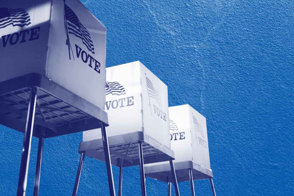 Voting booths with a navy and white color overlay on a concrete textured blue background