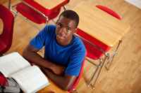 Teen male at school desk